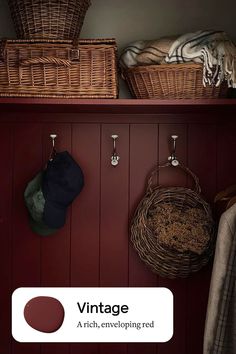 a shelf with baskets and hats hanging on it's sides next to a coat rack