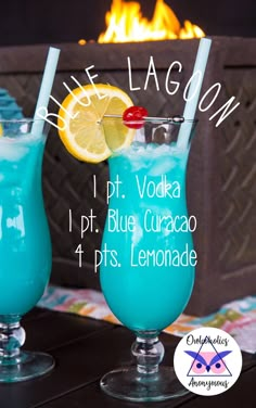 two glasses filled with blue curacano next to a fire place and sign that says, ice lagoon