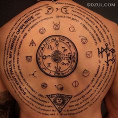 the back of a man's upper body with many different symbols and numbers on it