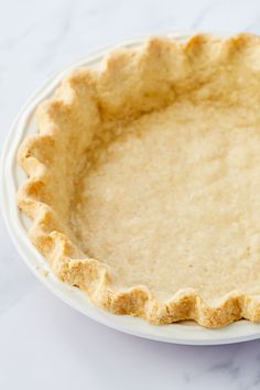 an uncooked pie crust on a white plate