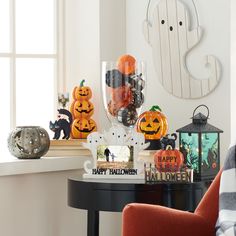 a table with halloween decorations and pumpkins on it