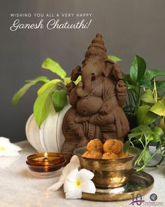 an elephant statue sitting on top of a table next to a bowl filled with food