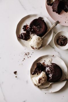 three plates with desserts on them sitting on a counter top next to each other