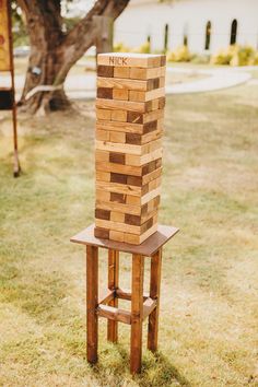 a stack of wooden blocks sitting on top of a chair in the middle of a yard