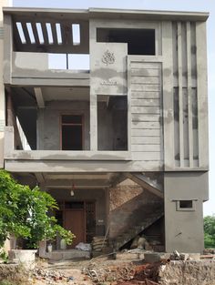 an unfinished building with stairs leading up to it