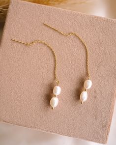 Add a touch of whimsy to any outfit with our brand new Phoebe Pearl Threaders! These delicate earrings feature a playful threader design that effortlessly loops through your ear for a unique & minimalist look. Adorned with freshwater pearls, they're sure to elevate any outfit! EARRINGS FEATURE Material: 14K Gold Filled or Sterling Silver threader Freshwater pearls Hand wire-wrapped with 14K gold filled or Sterling Silver wire Hypoallergenic & great for sensitive skin Adjustable Dangle Threader Earrings, Delicate Threader Earrings With Adjustable Chain, Dainty Adjustable Threader Earrings, Dainty Pearl Charm Dangle Threader Earrings, Dainty Dangle Threader Earrings With Pearl Charm, Minimalist Pearl Chain Threader Dangle Earrings, Delicate Adjustable Threader Earrings With Long Drop, Minimalist Dangle Threader Earrings With Pearl Charm, Dainty Pearl Dangle Threader Earrings