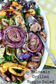 a white plate topped with meat and veggies on top of a yellow table cloth