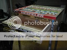 a table that has been made out of magazines and other items on it with the words protect more of your memories for less