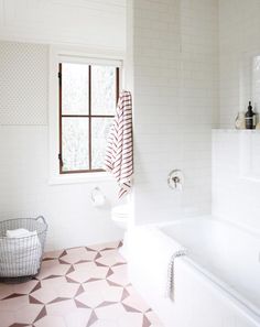 an instagram page with a white bathroom and pink floor tiles