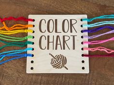 a wooden sign that says, color chart with yarn on the front and back side