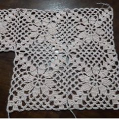 a crocheted doily is shown on a table