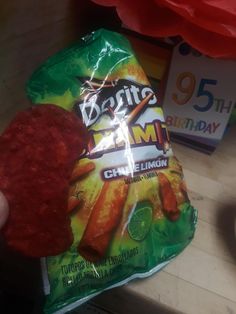 a bag of food sitting on top of a table next to a package of chips