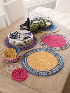 a wooden table topped with lots of plates and bowls