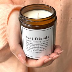 a person holding a candle in their hands with the words best friends written on it