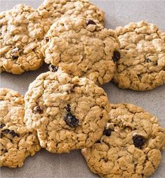 cookies with raisins and cranberries are arranged on a baking sheet, ready to be eaten