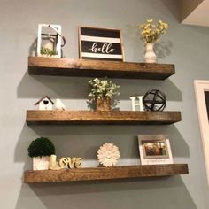 three wooden shelves with pictures and decorations on them