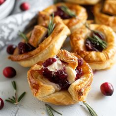 small cranberry pies on a plate with rosemary sprigs