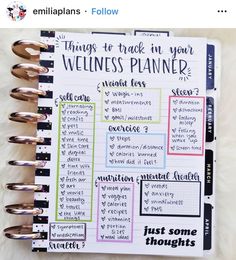 a planner with the words things to track in your wellness planner