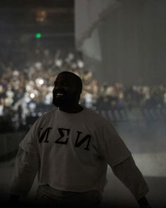 a man standing in front of a crowd at night