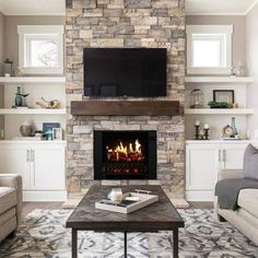 a living room filled with furniture and a flat screen tv mounted on the wall above a fire place