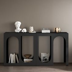 a black table with books and vases on it