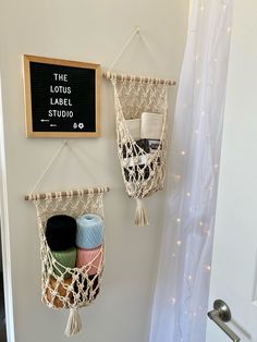 there are two macrame baskets hanging on the wall