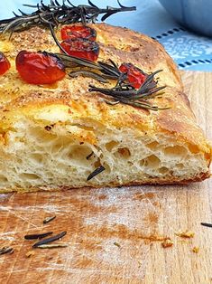 a piece of bread with tomatoes and herbs on it