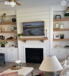 a living room filled with furniture and a flat screen tv mounted on the wall above a fireplace