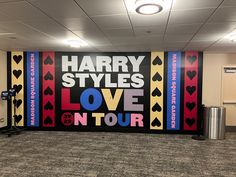 a stage set up for harry styles love tour in an office building with carpeted flooring