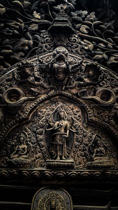 an intricately carved metal door with carvings on it