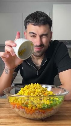 a man is pouring corn into a bowl