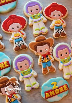 cookies decorated with the characters of toy story books are displayed on a wooden table top