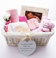 a white basket filled with baby items and a card saying twinkle twinkle little star to you know how loved you are