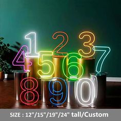 the numbers are lit up in different colors and sizes, along with two planters