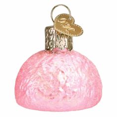 a pink glass ornament with a gold heart on it's top and a key hanging from the front