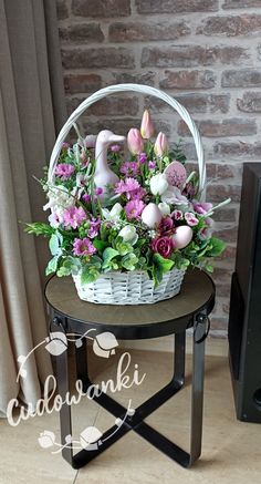 a basket filled with flowers sitting on top of a table