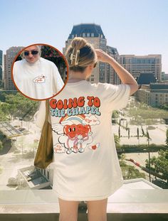 a woman standing on top of a building next to a man wearing a t - shirt