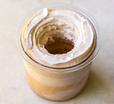 a jar filled with cream sitting on top of a table