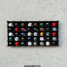 a display case filled with different types of football helmets