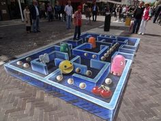 a man standing on top of a blue maze