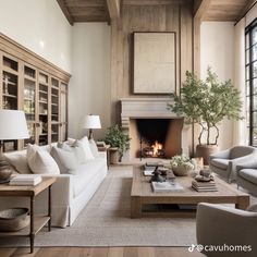 a living room filled with furniture and a fire place in the middle of a room