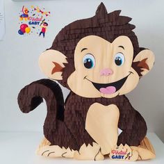 a paper cut out of a monkey sitting on top of a table