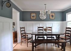 a dining room table and chairs in front of two windows with white waives on the wall