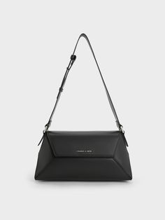 This product is made with at least 20% sustainable materials by weight. CHARLES & KEITH uses recycled, degradable, organic, and water-based materials in our eco-conscious collection.Chic and sophisticated, our Nasrin geometric shoulder bag is the perfect piece to complement any look. Whether you are going for a cool-girl aesthetic or a casual going-out look, it will complete any outfit without fail. Bonus points for the contrast stitch-trim detailing on the asymmetric panels. Between the clean l Modern Shoulder Bag With Single Strap, Modern Crossbody Baguette Bag, Modern Geometric Shoulder Bag For Travel, Chic Geometric Shoulder Bag For Everyday, Modern Geometric Shoulder Bag For Everyday, Geometric Shoulder Bag For Everyday, Modern Geometric Travel Shoulder Bag, Charles And Keith Shoulder Bag, Modern Black Shoulder Bag With Branded Hardware