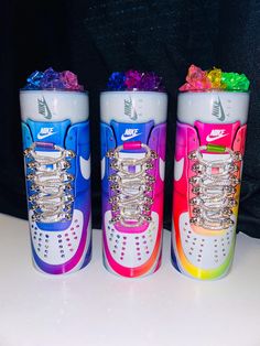 three colorful nike sneakers with chains on them