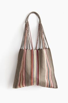 These versatile totes are handwoven by artisans in Chiapas, Mexico on a backstrap loom. Perfect for a beach day, the farmer's market, or as an everyday purse! Designed by and created exclusively for The Global Trunk. This bag is approx. 16" wide x 26" tall with the strap. Due to the handmade nature, height and width of bag can vary up to 10%. Eco-friendly Woven Hobo Bag, Eco-friendly Woven Hobo Bag For Everyday Use, Everyday Handwoven Jute Hobo Bag, Everyday Use Handwoven Jute Hobo Bag, Handwoven Jute Hobo Bag For Everyday Use, Eco-friendly Fair Trade Beach Bag For Everyday Use, Natural Color Tote Hobo Bag For Market, Natural Tote Hobo Bag For Market, Daily Use Artisan Handwoven Beach Bag