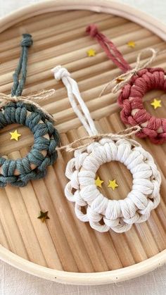 three bracelets are tied together on a bamboo tray with string and star decorations around them