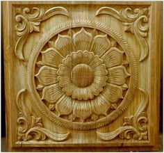 carved wood panel with an intricate flower design