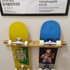 two skateboards are hanging on the wall