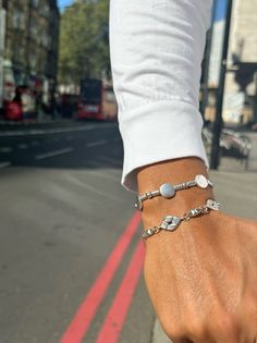 Two different Silver Bracelets for Men with unique beads and charms that are open and close with clasp. The first bracelet has as central beads, round charm and the second bracelet has oval beads that are connected between them with unique small charms and create a really special result. Both bracelets have extension at the joined edges for perfect fit. Choose between four different dimensions. You can wear them together as set or separetely. Find them only at Christina Christi Store. 👉 My Mens Modern Silver Bracelets With Charms, Modern Silver Friendship Bracelets, Everyday Bracelets With Charms And Round Beads, Silver Sterling Silver Friendship Bracelets For Everyday, Modern Silver Beaded Bracelets For Jewelry Making, Modern Silver Beaded Bracelets For Everyday, Nickel-free Sterling Silver Friendship Bracelets, Silver Minimalist Beaded Bracelets, Silver Minimalist Beaded Bracelet